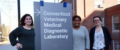 three women in front of CVMDL sign